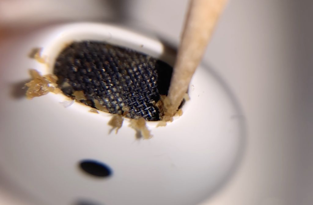 Picture of removing ear wax from airpods using toothpick