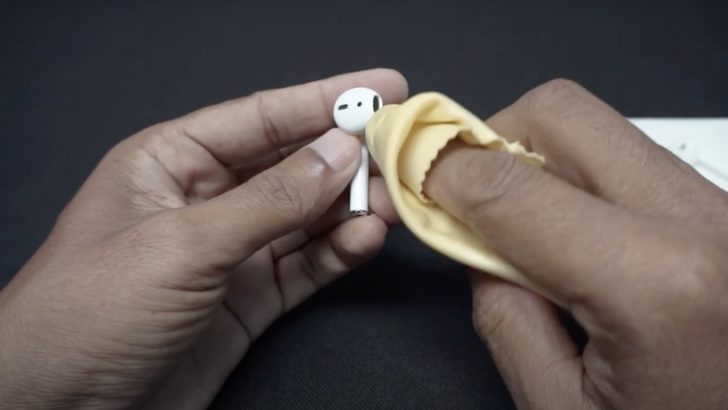 Photo of person cleaning airpods using lint free cloth