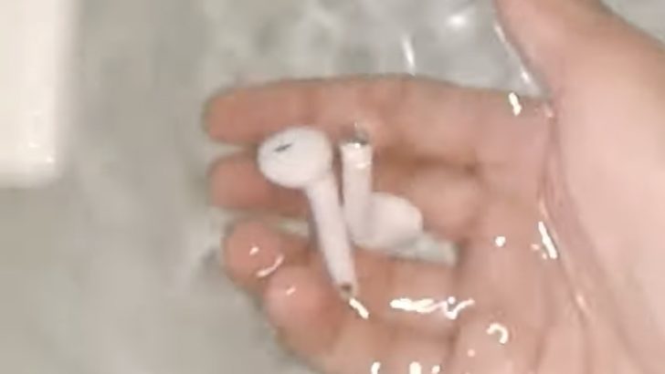 Photo of person removing airpods from water