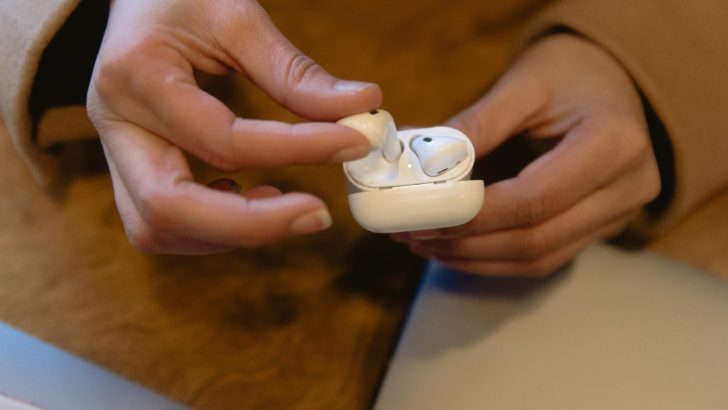 Photo of person putting airpods inside the case