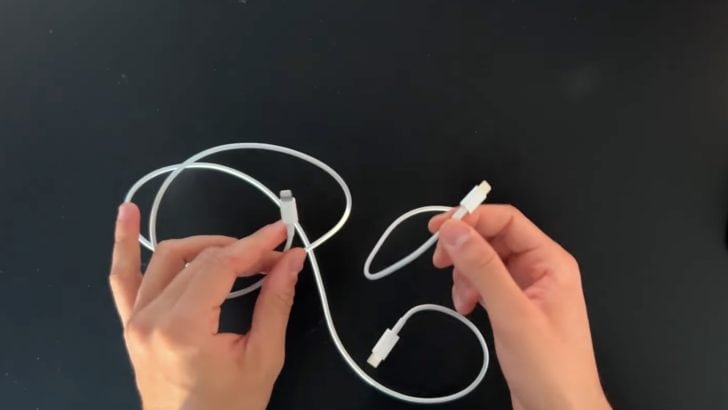 Photo of person comparing fake and original apple cables