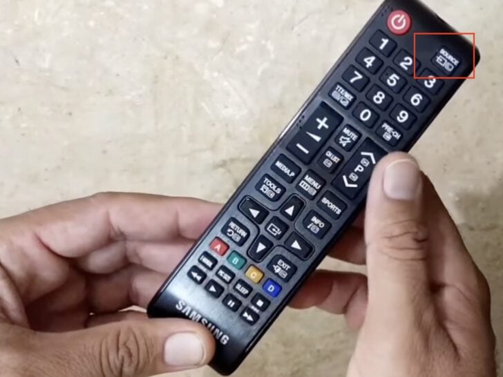 Photo of person holding samsung tv remote