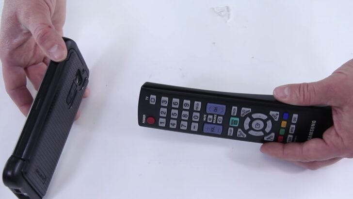 Photo of person testing samsung tv remote infrared signal using smartphone