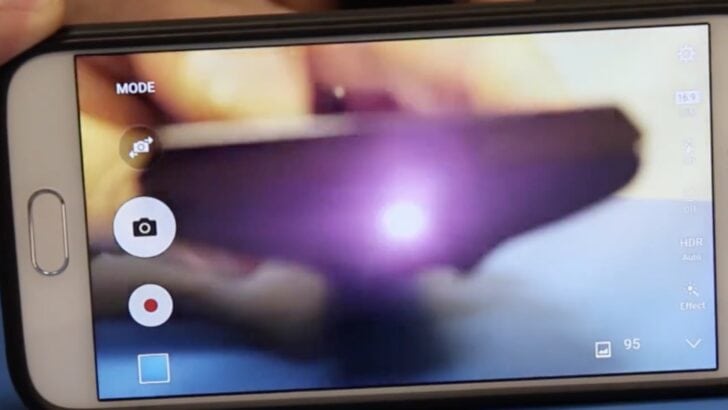 Photo of person testing vizio tv remote infrared signal using smartphone camera