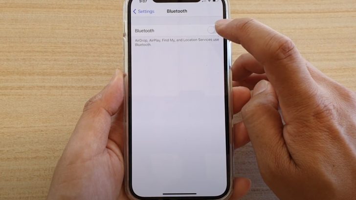 Photo of person turning bluetooth on in phone