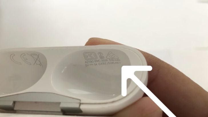 Photo of airpods serial number underneath the charging case lid