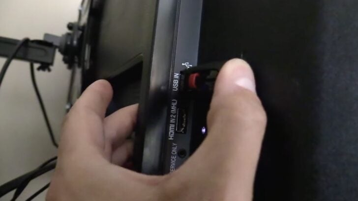 Photo of person plugging usb into lg tv