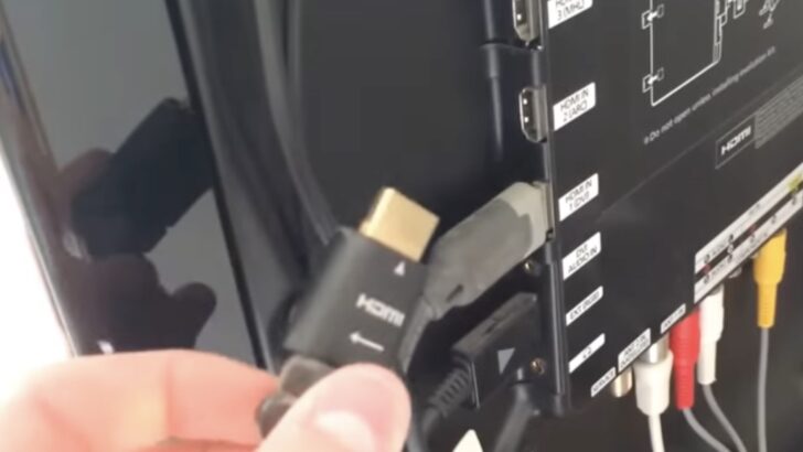 Photo of person unplugging hdmi cable from samsung tv