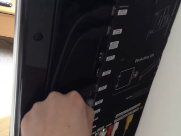 Photo of person unplugging hdmi cable from tv port