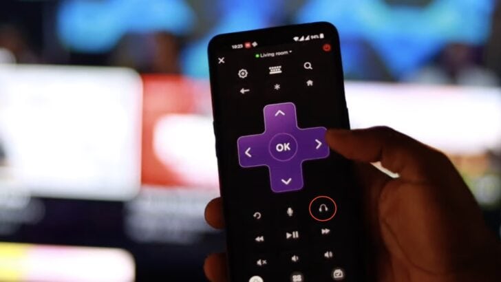 Photo of person using the roku app as remote