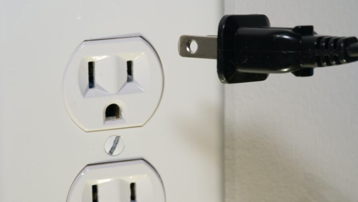 Photo of a power cord and a power outlet