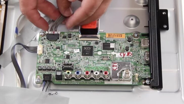 Photo of person removing lg tv mainboard