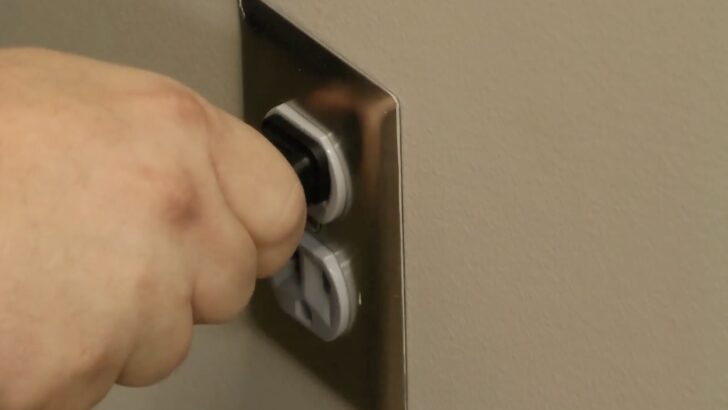 Photo of person unplugging vizio tv power cord from the power outlet