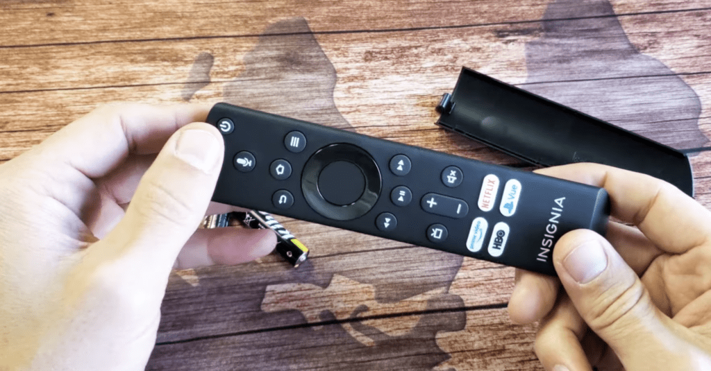 Photo of a person examining an Insignia TV remote