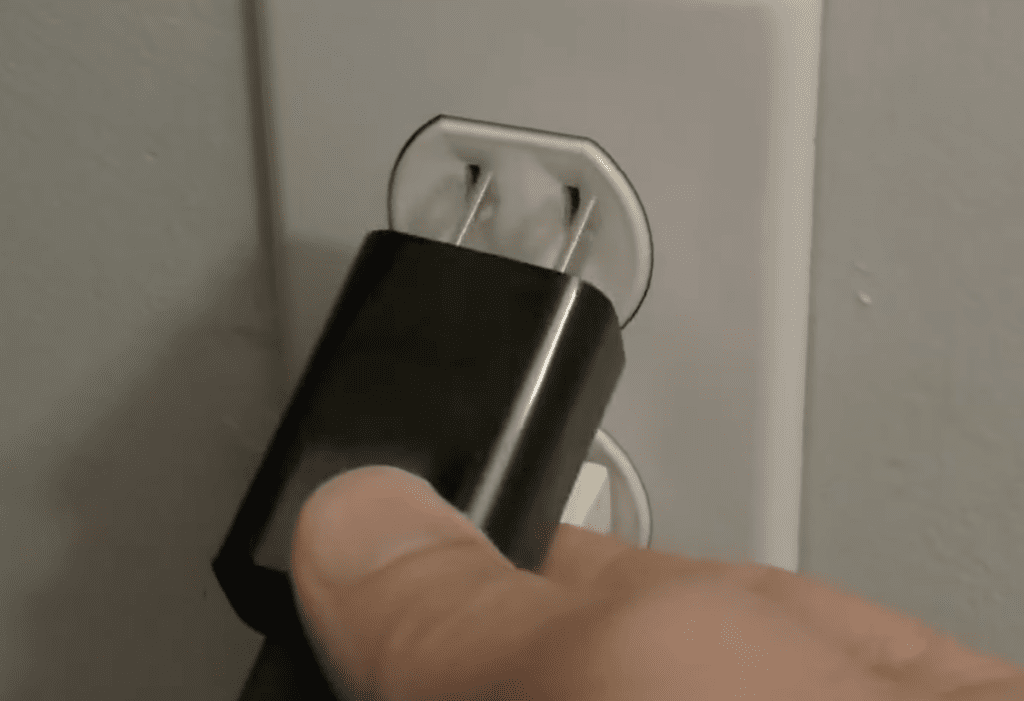 Photo of a person unplugging an Amazon Firestick from its power source