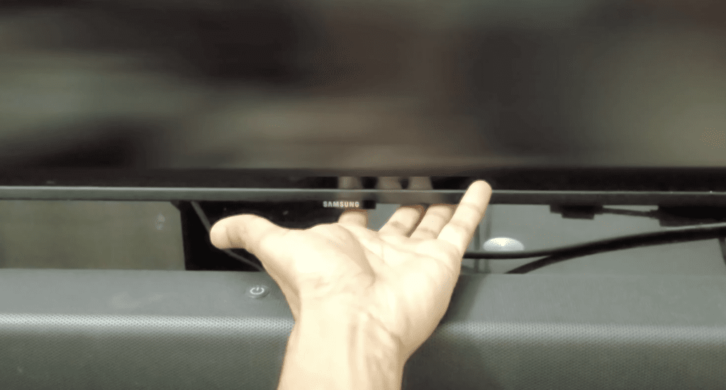 Photo of someone draining a Samsung TV's residual electrical charge by pressing the power button for 30 seconds
