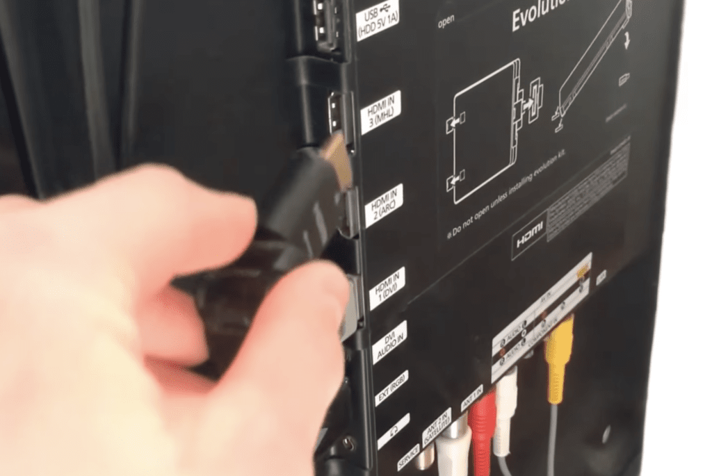 Photo of a person reseating the HDMI connection on a Samsung TV