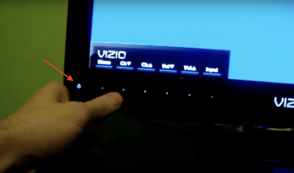 Photo of a person using the capacitive touch buttons of a Vizio TV