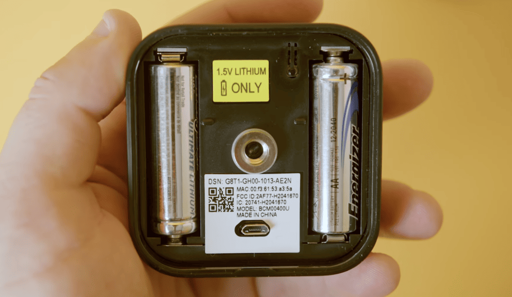 Photo of a Blink camera and its two AA batteries