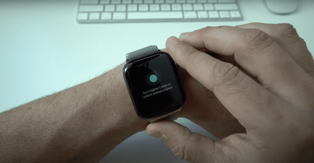 Man pressing the Digital Crown of his Apple watch until it's unlocked