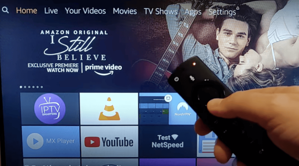 Photo of a person holding a firestick remote blinking orange