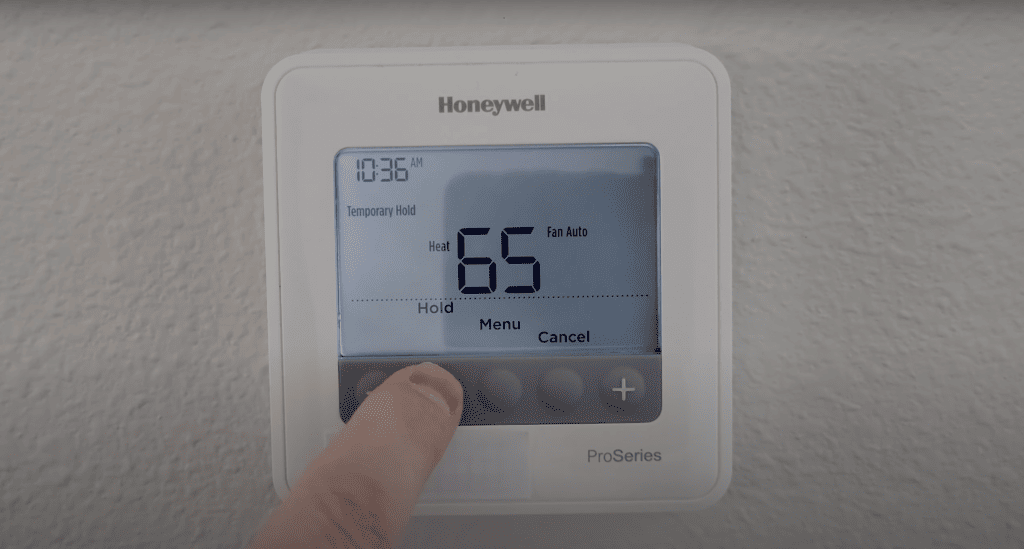 Pressing hold to temporary hold the Honeywell thermostat schedule