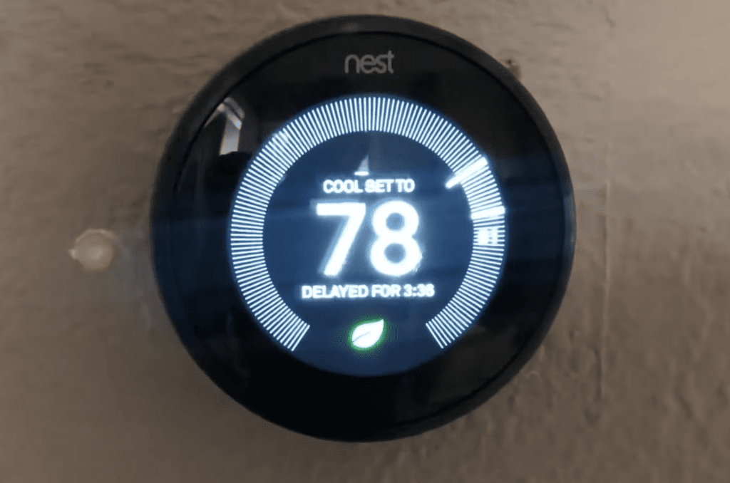 Photo of a Nest thermostat displaying a 