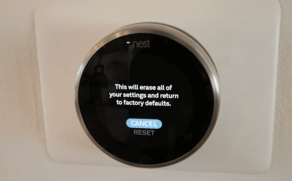 Photo of a Nest thermostat with factory reset message on its screen
