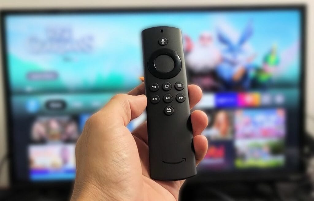 man holding a  Firestick remote with Alexa voice control