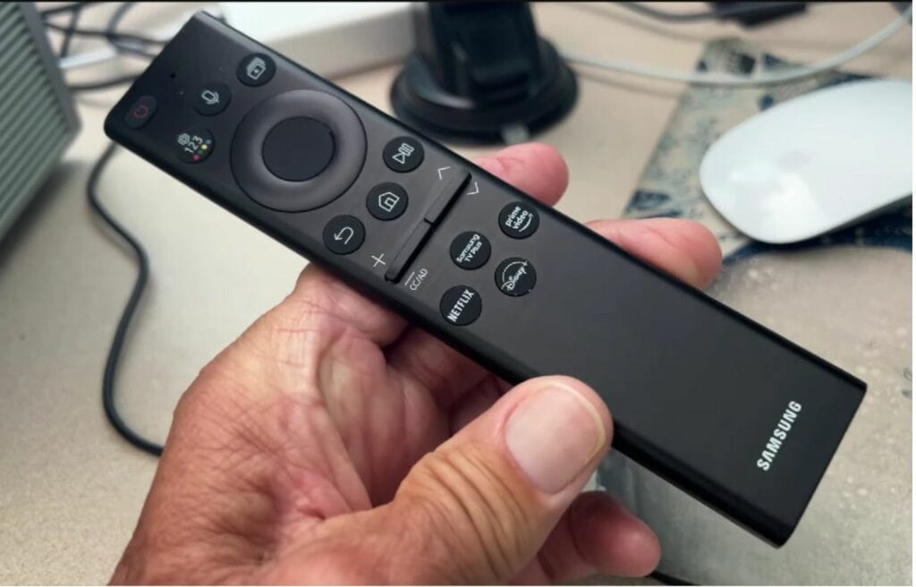 Hand holding a Samsung remote