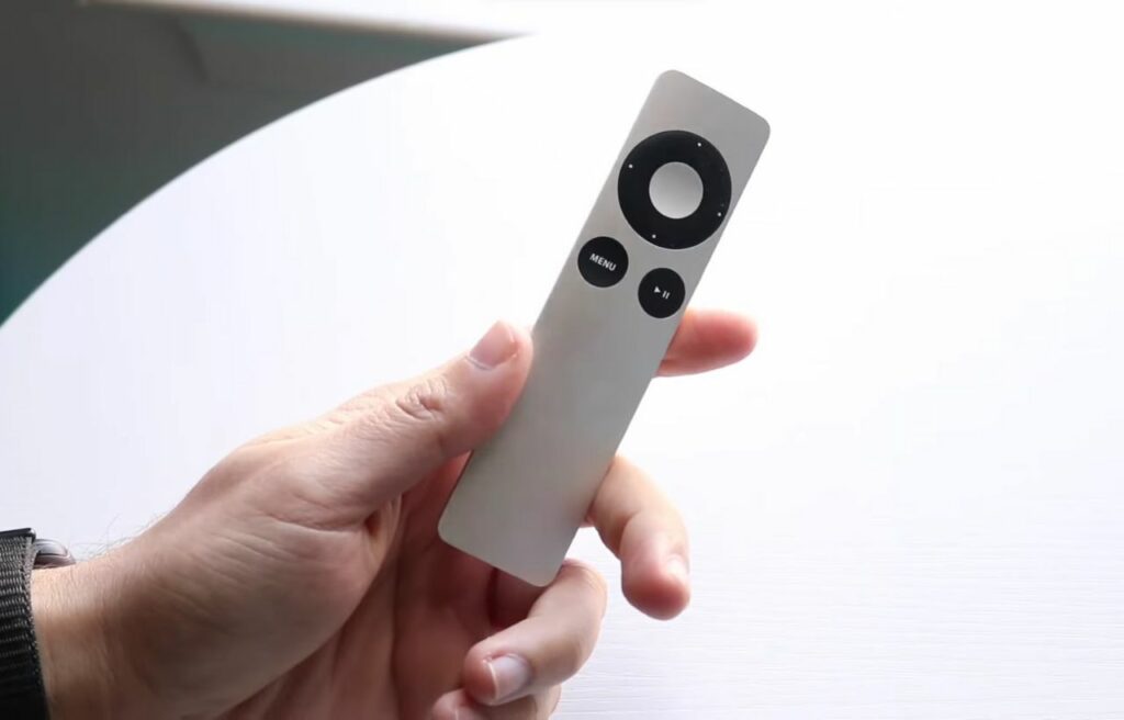 hand holding an Apple TV remote