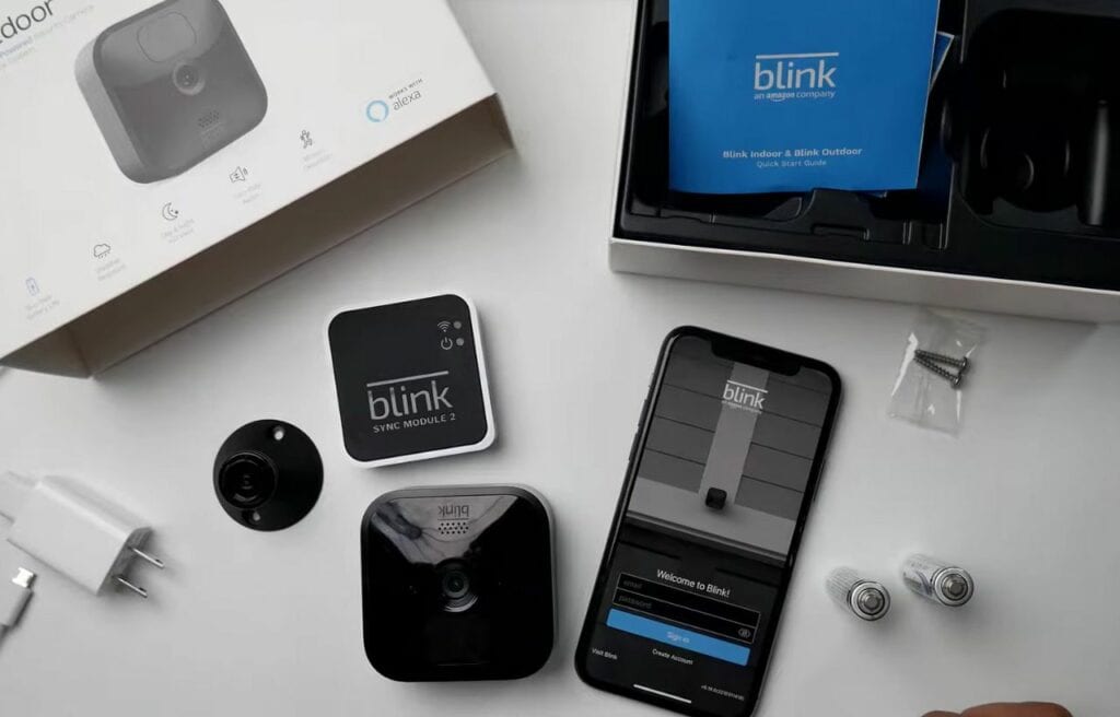 Blink Camera and a phone on a table