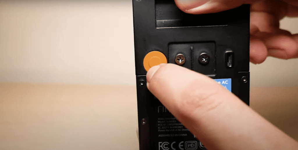 Press the orange button at the back of the Ring doorbell