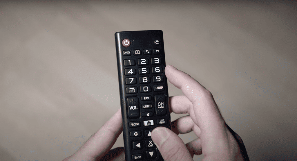 Man touching the Toshiba TV remote