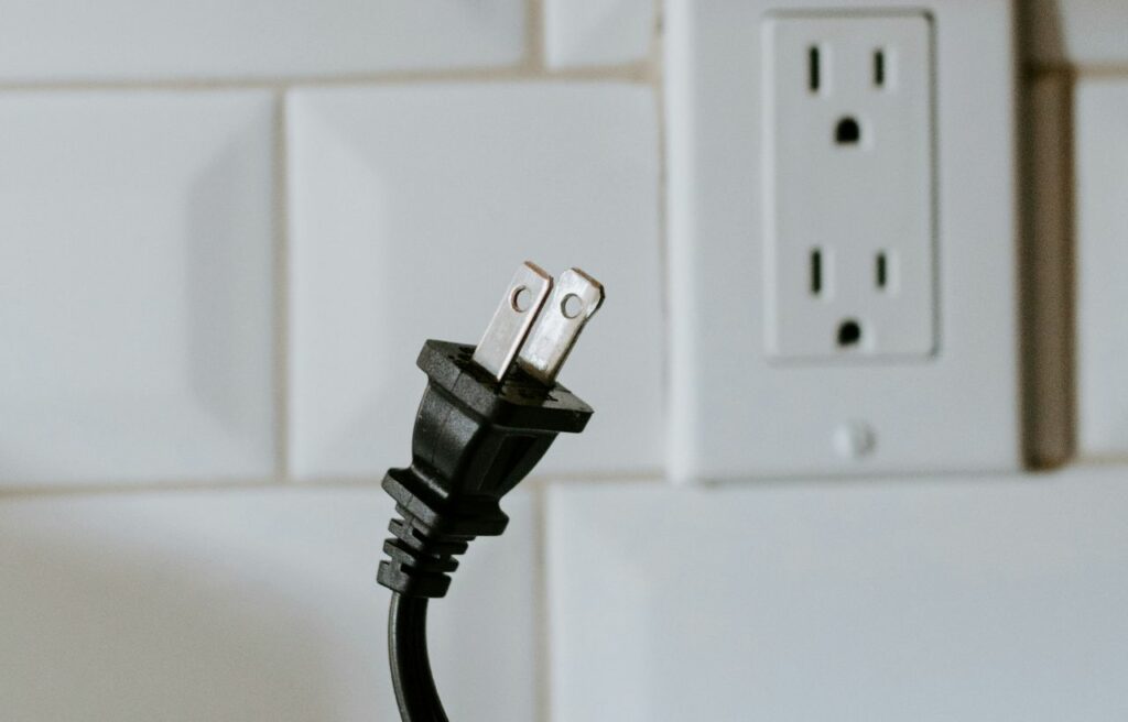 a power cord disconnected from a power socket